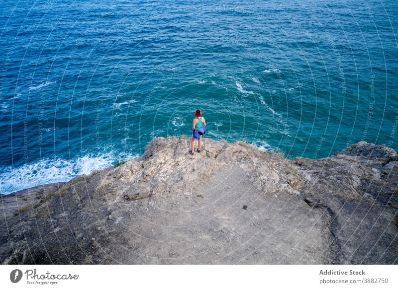Reisende Frau in Hügel in der Nähe von blauem Meer türkis MEER reisen beobachten Aussichtspunkt Sommer Urlaub Abenteuer bewundern Tourist Felsen Feiertag