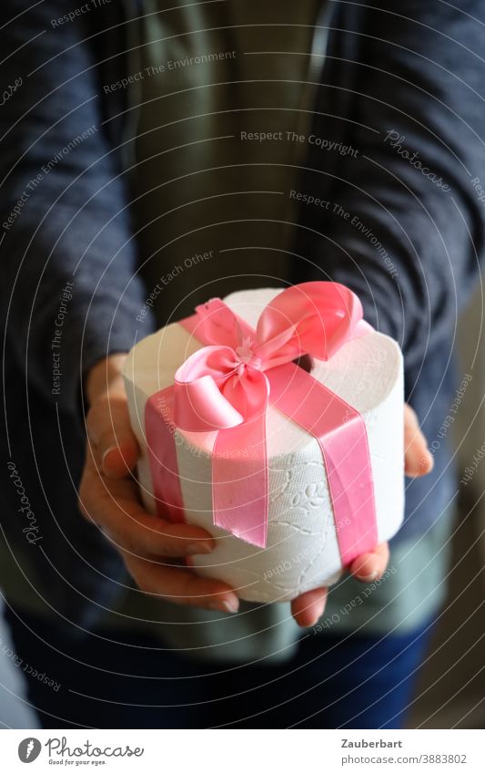 Klopapier Rolle mit rosa Geschenkband wird übergeben Schleife Übergabe Corona Hamstern Weihnachten Geburtstag schenken Weihnachtsgeschenk Bescherung