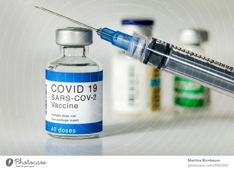 Konzept Kampf gegen das Covid-19-Coronavirus, Arzt oder Wissenschaftler im Labor, der eine Spritze mit flüssigen Impfstoffen hält. Konzept:Krankheiten,medizinische Versorgung,Wissenschaft