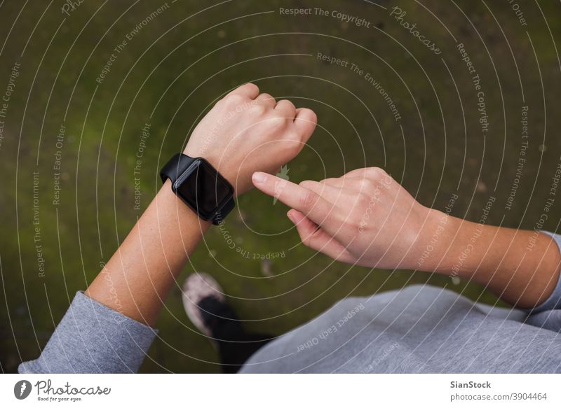 Nahaufnahme einer jungen Frau, die im Freien das Smartwatch-Gerät überprüft. zuschauen klug Fitness Sport smartwatch Gesundheit Athlet berühren berührend
