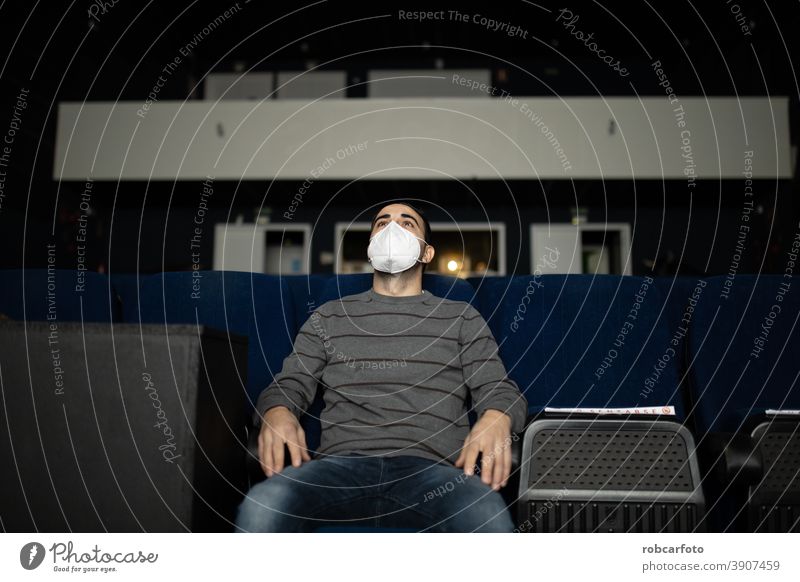 Mann, der mit Maske einen Film im Kino anschaut Filmmaterial Virus Pandemie Entertainment Sitz Publikum Sitzen covid-19 Mundschutz jung Frau COVID Projektion