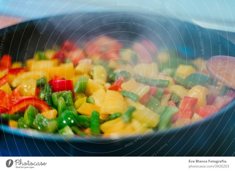unerkennbar Frau bereitet Gemüse Essen in der Pfanne. Gesundes Essen Lebensmittel Küche Paprika farbenfroh Gesundheit rühren tiefstehend Möhre Kohlgewächse