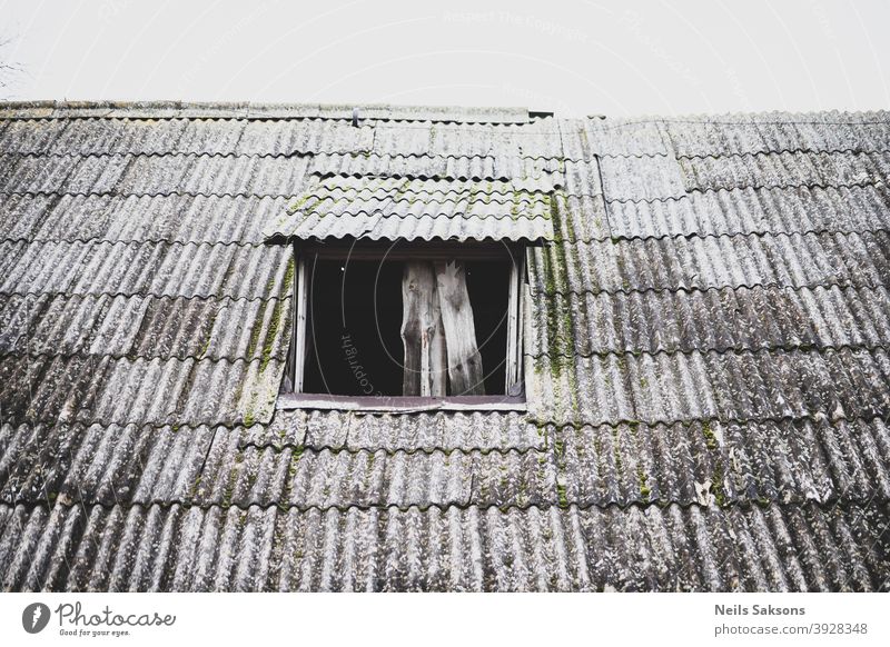 schiefes gewelltes Schieferdach einer alten Scheune mit Dachfenster ohne Glas abstrakt gealtert Architektur Asbest Hintergrund erbaut Keramik Konstruktion