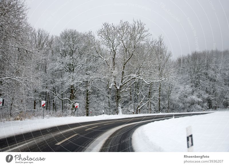 gefährlich glatte Straße mit Schneeverwehungen straße landstraße bundesstraße verkehr straßenverkehr schnee glätte winter wintereinbruch fahrbahn verkehrsregeln