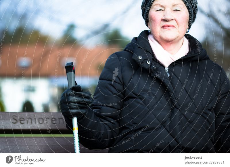 Pause auf ihrem Weg Frau Seniorin Ruhestand Seniorenbank Porträt Winterjacke Mütze Laufstock Halstuch Freizeit & Hobby aktivität Lifestyle Unschärfe ernst