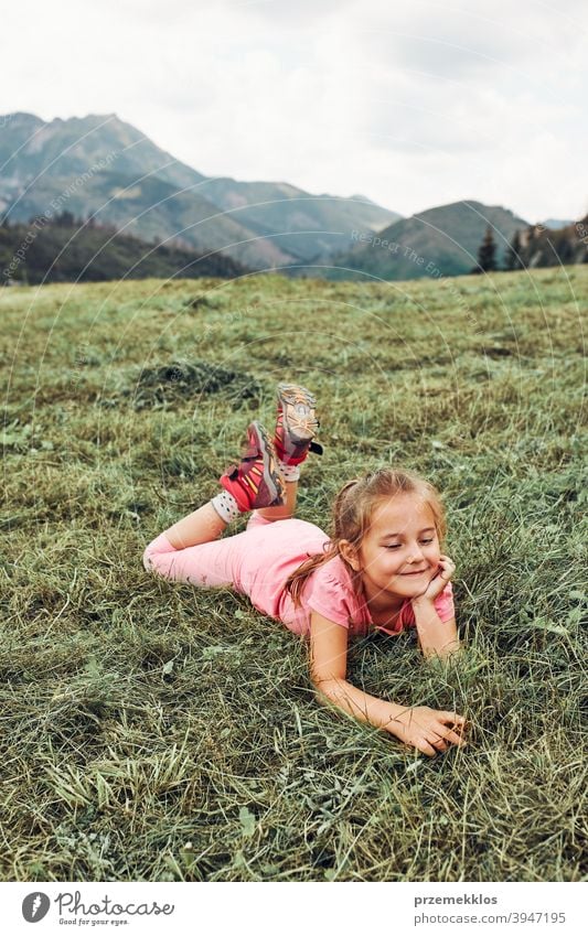 Kleines Mädchen liegend spielen auf Gras genießen Sommertag während Urlaub Reise Glück Aufregung Genuss Freizeit Ausflug Spielen Emotion positiv Lügen Lifestyle