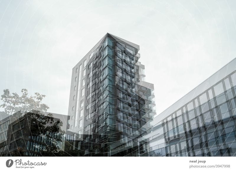 Doppelbelichtung – Architekturaufnahme eines Hochhauses Fassade Glas Backstein modern Wohnen kühl Struktur monochrom gedeckte farben blau grau Menschenleer