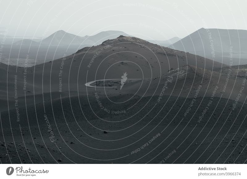 Vulkanische Landschaft der Kanarischen Insel Straße Kurve Kanarische Inseln Lanzarote Timanfaya Hintergrund wandern Krater Kanarienvogel Hügel Berge u. Gebirge