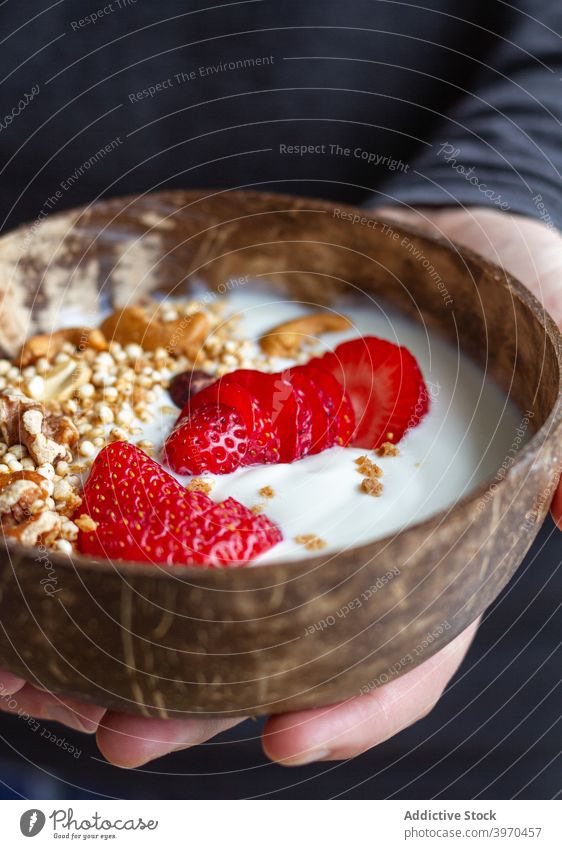 Crop Person mit Frühstücksschale Schalen & Schüsseln Supernahrung Gesundheit Lebensmittel Morgen lecker Joghurt Beeren Müsli Nut Ernährung Nährstoff Erdbeeren