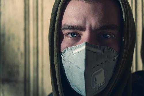 Porträt eines jungen Mannes mit einer FFP3-Koronamaske Mundschutz ffp3 Schutz Pandemie Verschmutzung Virus Gesundheitswesen Krankheit Infektion schützend
