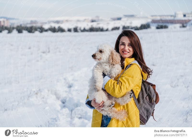 Backpacker Frau Wandern im Freien mit niedlichen Pudel Hund. Snowy Berg in der Wintersaison. Natur, Haustiere und Lebensstil Rucksack Berge u. Gebirge Schnee
