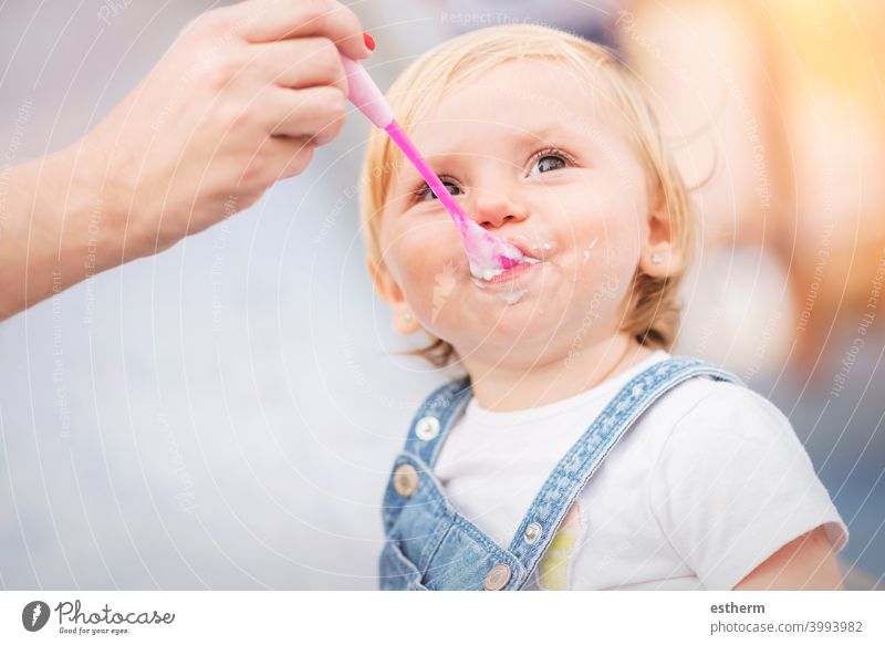 Baby isst im Freien aktiv anhänglich Kaukasier heiter Kindheit Zufriedenheit niedlich Molkerei Essen ausbilden Ausdruck Familie Väter Futter Spaß Wachstum