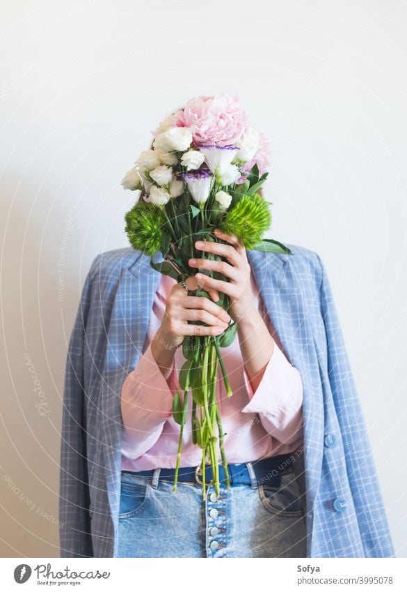 Frau in blauer Jacke hält pastellfarbenen Pfingstrosenstrauß Mutter Tag Lifestyle gesichtslos Blumenhändler Muttertag rosa Frühling Gesicht Frauentag
