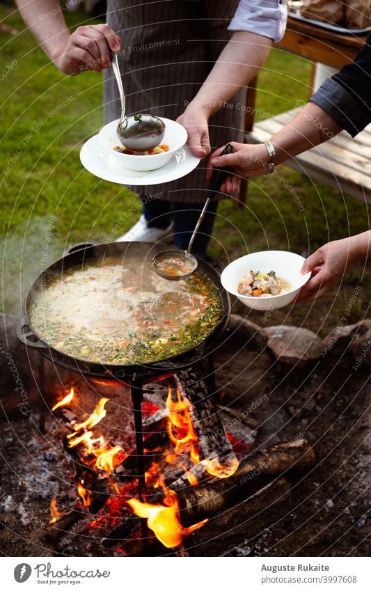 Koch macht Fischsuppe auf Feuer in der Natur Suppenteller Wald Natur-Foto Camping Campingplatz Foodfotografie Lebensmittelprodukte Futterneid warme Speisen