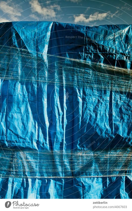 Blaue Plane plane folie verpackung eingewickelt paket versand schutz regenschutz wetterschutz eingeschnürt material kunststoff gewebe blau
