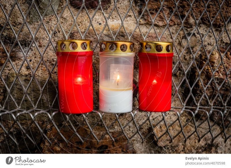 Nahaufnahme Foto für Satz von drei rot weiß rot brennenden Kerzen bei Gedenkveranstaltung in Riga, Lettland, die lettische Flagge Farben auf gebrannten Hintergrund