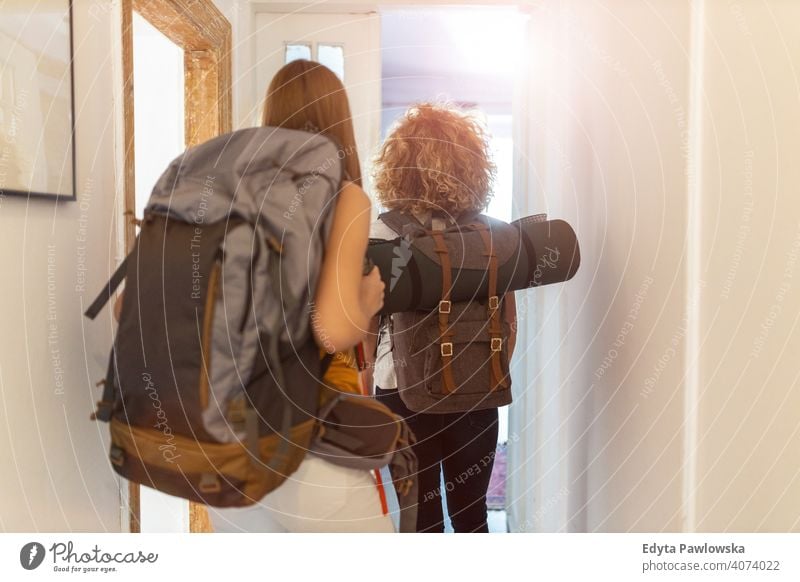 Junge Frauen mit Rucksäcken bei der Ankunft in einer Jugendherberge airbnb Miete reisen Tourist Herberge Gästehaus Ferien Reise flach Rucksack Backpacker