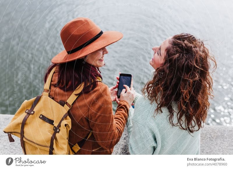zwei Frauen Sightseeing Porto Ansichten durch den Fluss und nehmen Bild mit Handy. Reisen und Freundschaft Konzept Freunde Großstadt Technik & Technologie