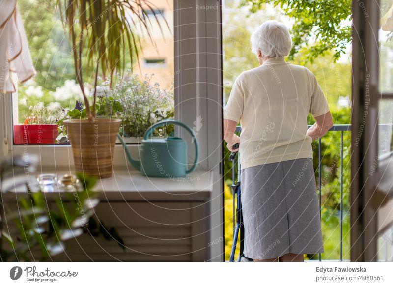 Seniorin mit Rollator auf ihrem Balkon stehend Menschen Frau reif lässig Kaukasier älter heimwärts Haus alt Alterung häusliches Leben Großmutter Rentnerin