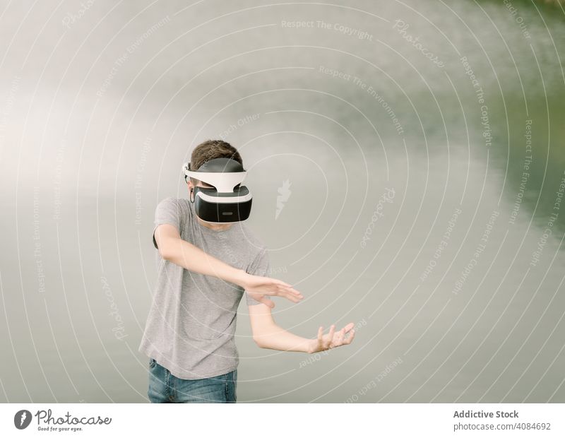 Junger Teenager mit Virtual-Reality-Brille im Freien virtuell Realität VR Jugendlicher Natur Headset Technik & Technologie Spiel futuristisch 3d jung modern