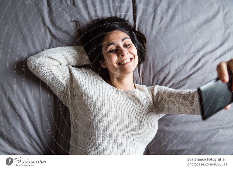 Junge Frau nimmt ein Selfie auf dem Bett jung Kaffee Lifestyle lässig Internet Business Vernetzung sozial Haus heimwärts Schlafzimmer Morgen