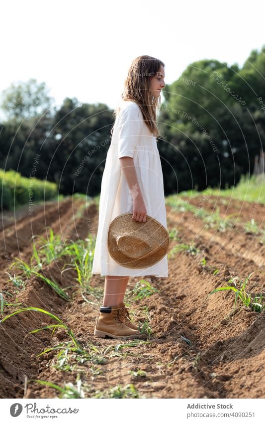 Teenager zu Fuß auf Bauernhof Feld Hut laufen Sprossen Ausgewogenheit Sommer Natur ausgestreckte Arme sonnig tagsüber Katalonien Spanien Anoia Mädchen jung