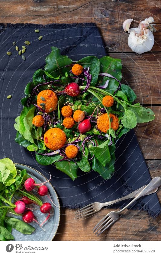Sojabällchen und Rettich auf Rote-Bete-Blättern Rote Beete Bälle Salatbeilage Veganer Speise Tisch Serviette Gabeln Lebensmittel grün Vegetarier Gesundheit
