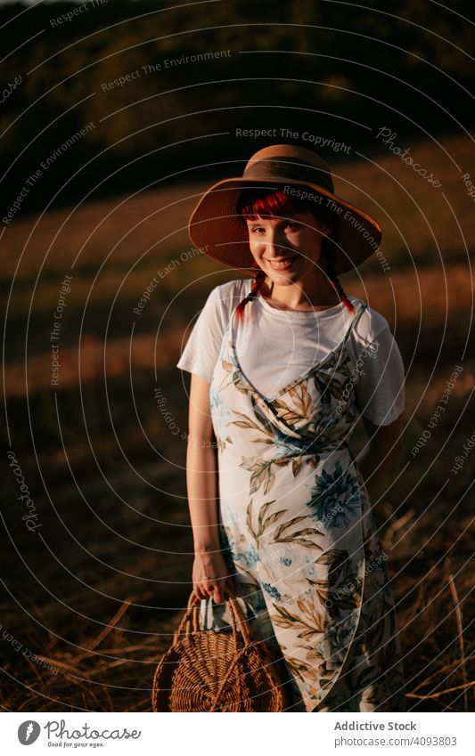 Frau geht im Feld Spaziergang Sonnenuntergang retro Natur Abend Himmel Landschaft Lifestyle Sommer Wiese altehrwürdig Kleid Hut Harmonie idyllisch Windstille