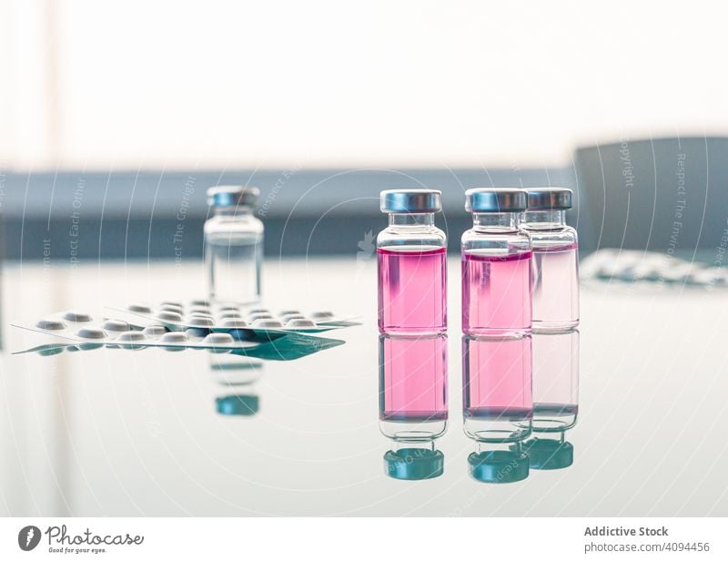 Fläschchen mit wissenschaftlichen Proben auf einem Glastisch Ampulle Chemikalie liquide Experiment Flasche Reaktionen u. Effekte Labor Reihe medizinisch