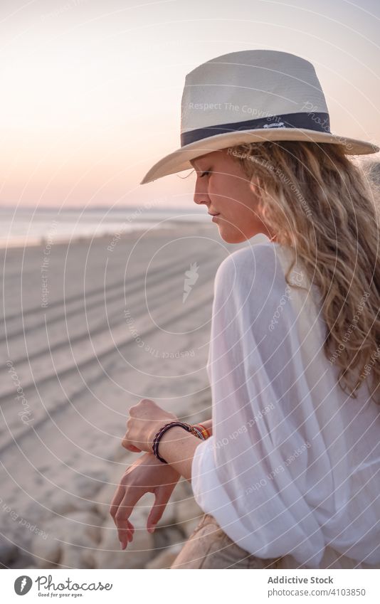 Charmante Frau mit Hut lehnt sich an einen Zaun und schaut aufs Meer Strand Mädchen Porträts Sommer MEER reisend Lehnen Seeküste Tourismus charmant Urlaub