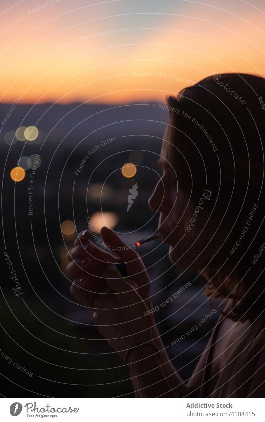 Frau mit Feuerzeug und Zigarette in der Abenddämmerung sich[Akk] entspannen Rauchen aussruhen Sonnenuntergang Natur Himmel Himmel (Jenseits) Dame Lifestyle