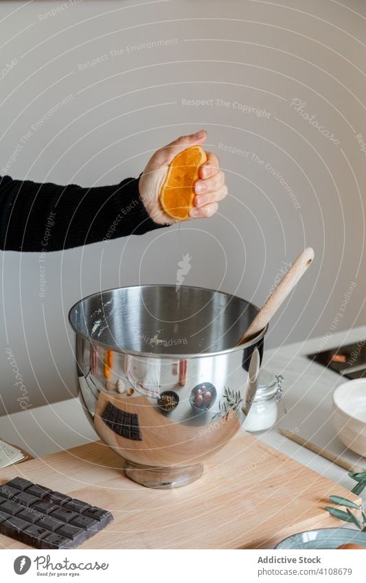 Frau, die eine Orange über einer Schüssel auspresst drücken orange Schalen & Schüsseln vorbereiten Rezept Bestandteil Küche Hand Lebensmittel Koch heimwärts