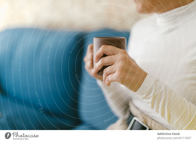 Anonyme Person mit Kaffeetasse auf der Couch Frau ruhen Liege Business Büro Becher Kälte Getränk trinken Freizeit modern lässig Lächeln Tasse Erwachsener