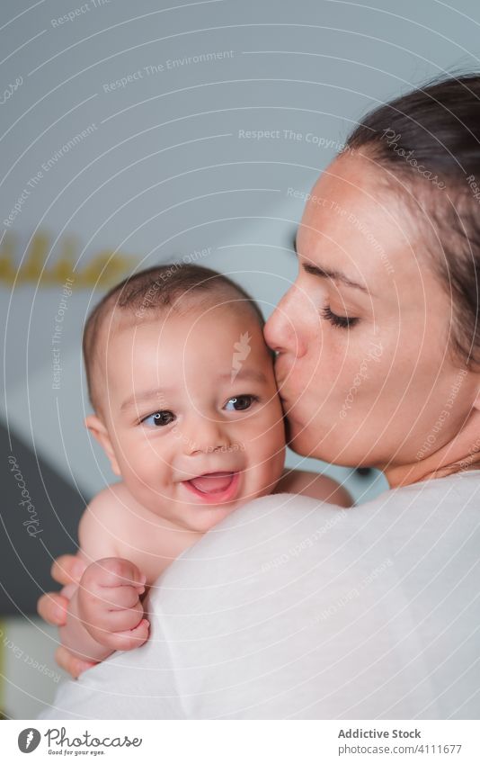 Freudige Mutter mit Baby im Schlafzimmer führen Lächeln Lachen genießen zufrieden wenig Glück Kind bezaubernd Liebe niedlich Zusammensein Pflege Angebot
