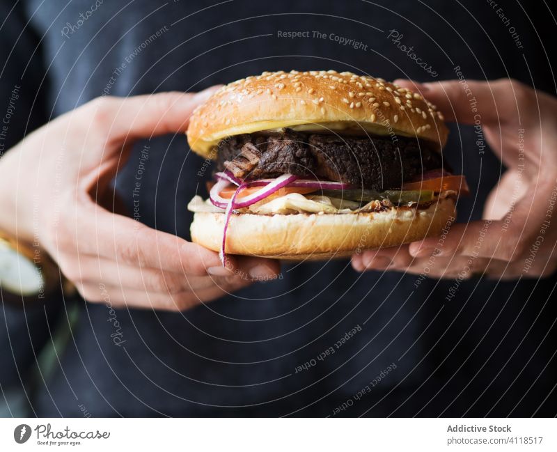 Person hält einen Hamburger in den Händen Burger Fastfood Snack Junk Food Fleisch Rindfleisch Mittagessen Hand Abendessen ungesund Mahlzeit Küche Brötchen