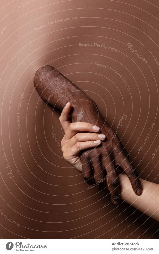 Unerkennbar Ernte multirassischen Paar hält Hände hinter Papier Vorhang Händchenhalten Hand schließen Menschen sich[Akk] entspannen sinnlich Umarmen Partner