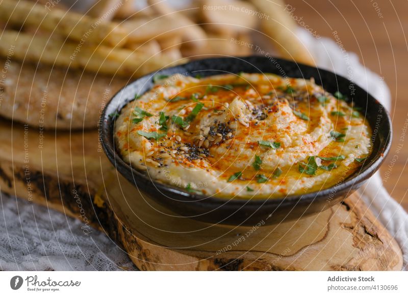Hausgemachter Hummus auf einem Holztisch Amuse-Gueule Schalen & Schüsseln Brot Kichererbsen cremig Dip Lebensmittel Gesundheit selbstgemacht Mittagessen