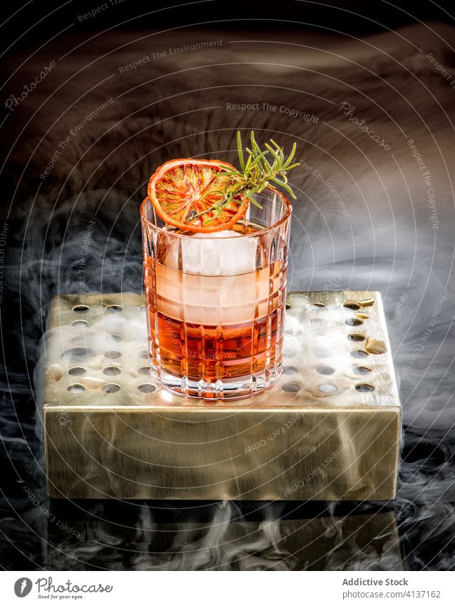 Glas kalter Cocktail mit Orange und Eis trinken rot Zitrusfrüchte orange Alkohol Rosmarin frisch Getränk liquide lecker Bar Party Frucht Scheibe dienen