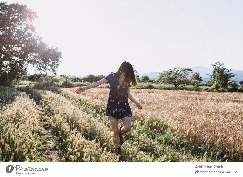 Fröhliche Frau läuft über ein Feld laufen Landschaft sorgenfrei Wochenende Sommer sonnig Freiheit heiter Gummi Stiefel Kleid Sonne Freude Wiese Natur Harmonie