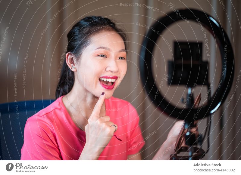 Schönheitsbloggerin, die sich während des Shootings schminkt vlog Blogger Frau Make-up bewerben Kosmetik Fundament Aufzeichnen Video jung asiatisch ethnisch