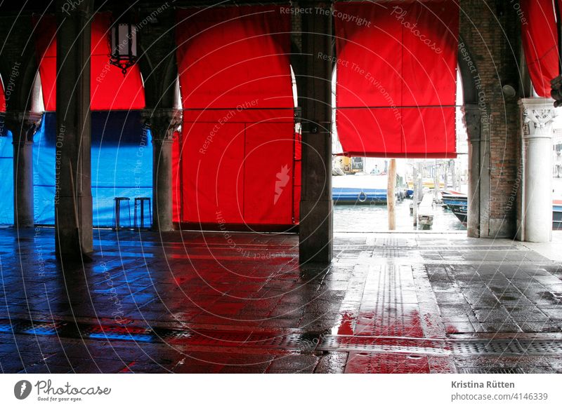 rote rollos an der fischhalle in venedig fischmarkt markthalle blau arkaden säulen architektur leer stimmung feierabend nass pescheria rialtomarkt canal grande
