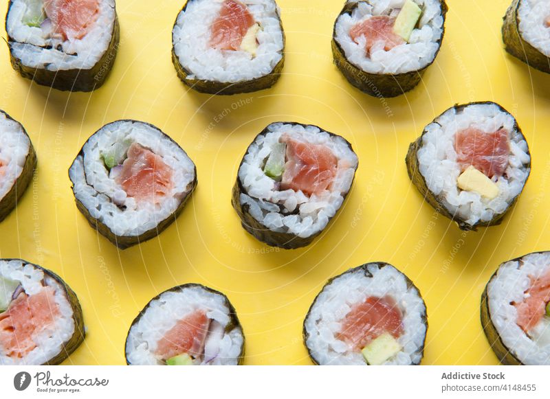 Appetitliche Sushi-Rollen auf gelbem Hintergrund rollen Atelier Lachs Reis lecker Asiatische Küche geschmackvoll Tradition Japanisch Lebensmittel Mahlzeit Tisch