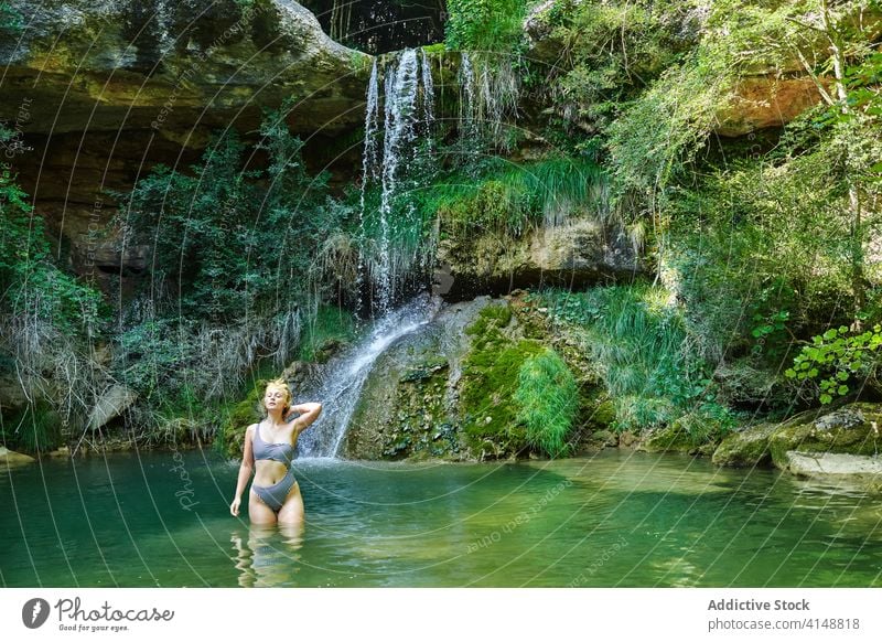 Frau in Badehose im See Wasserfall Wald genießen Bikini Urlaub Badebekleidung Reisender Sommer Feiertag Natur sich[Akk] entspannen Tourismus reisen Abenteuer
