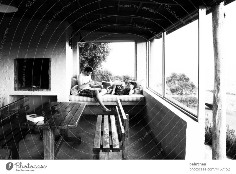 zeit zusammen Sonnenlicht Kontrast gemütlich Erholung Südafrika Fernweh Sofa Veranda Fenster genießen Sehnsucht Ferne Junge Familie & Verwandtschaft Kindheit