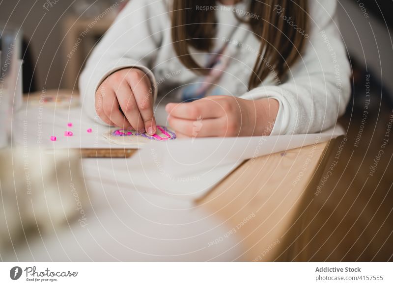 Crop Kind spielt am Tisch zu Hause spielen Bildung motorische Fähigkeiten wenig Mosaik heimwärts Spielfigur farbenfroh niedlich Aktivität spielerisch