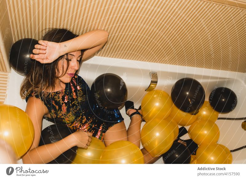 Junge Frau in Badewanne mit Luftballons nach Party schlafen müde festlich feiern Feiertag Veranstaltung jung lustig ruhen Anlass Weihnachten betrunken Farbe