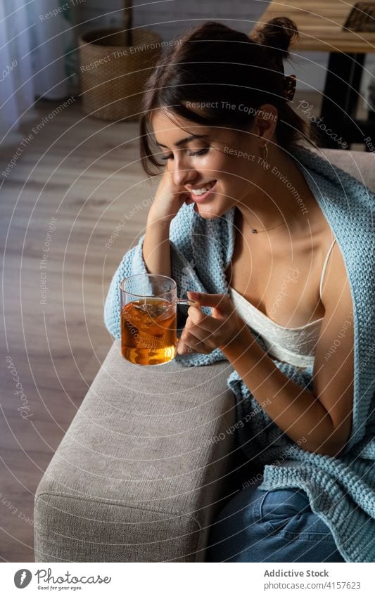 Nachdenkliche Frau trinkt Tee auf dem Sofa trinken besinnlich gemütlich heimwärts nachdenklich sich[Akk] entspannen Kälte jung warm Liege Komfort Getränk ruhen
