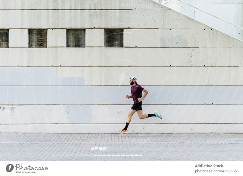 Fit Mann läuft entlang Straße in der Stadt Läufer Großstadt laufen urban Training Herz passen Ausdauer männlich dynamisch Straßenbelag Moment Sportler aktiv