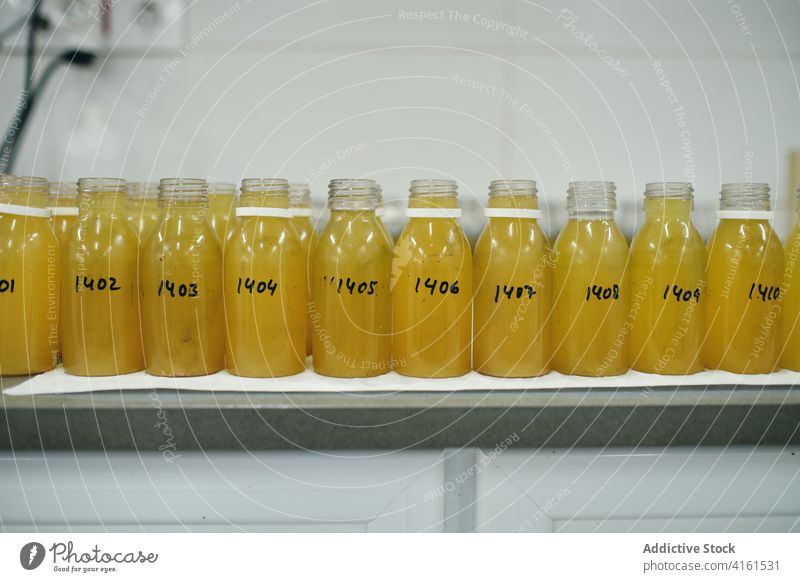 Fläschchen mit chemischen Flüssigkeiten im Labor Flasche liquide Chemikalie Chemie Tisch forschen Glas Ampulle Reihe Container durchsichtig Prüfung gelb