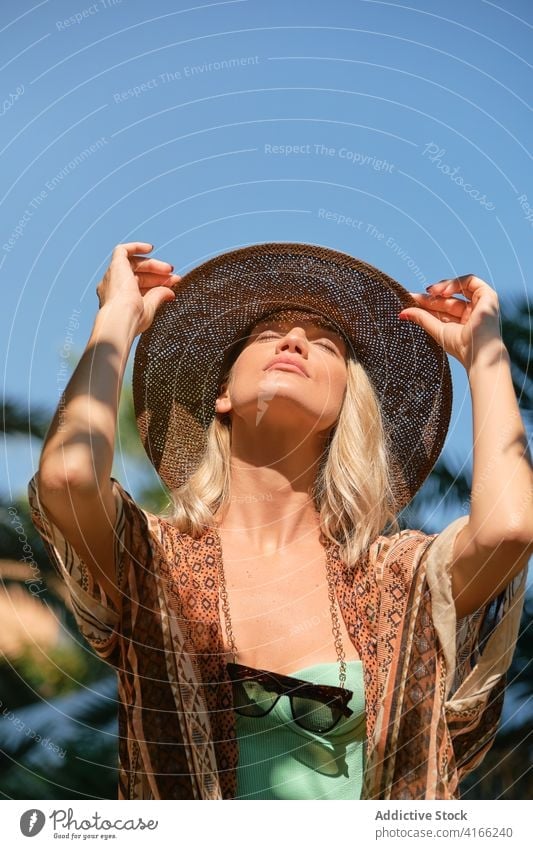 Serene Reisende ruht in Sonnenlicht gegen blauen Himmel Frau Resort ruhen Tourist blond Urlaub idyllisch Freiheit Harmonie Augen geschlossen Sommer